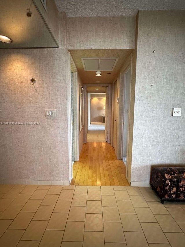 hall with light tile patterned floors