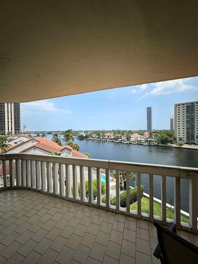 balcony with a view of city and a water view