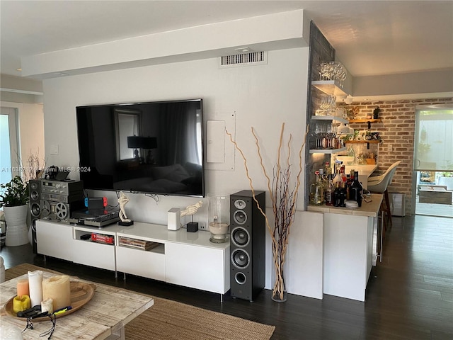 living room with plenty of natural light and dark hardwood / wood-style floors