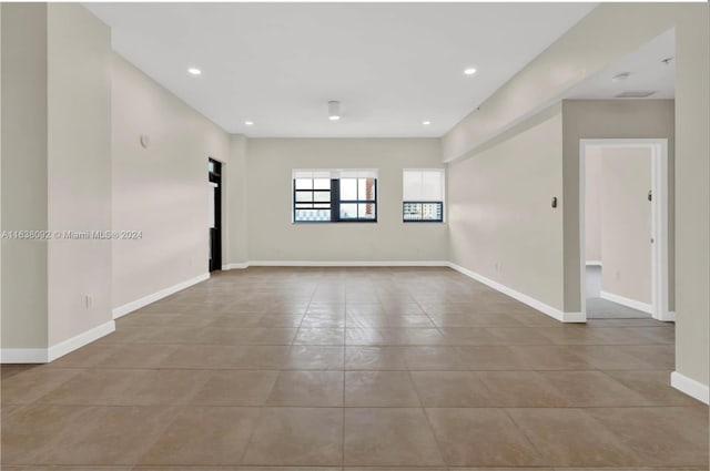 spare room featuring light tile patterned flooring