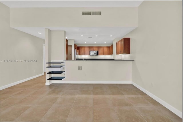 kitchen featuring light tile patterned floors and appliances with stainless steel finishes