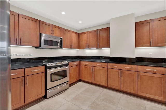 kitchen featuring light tile patterned floors and appliances with stainless steel finishes