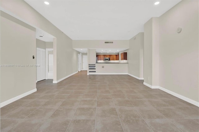 unfurnished living room with light tile patterned floors