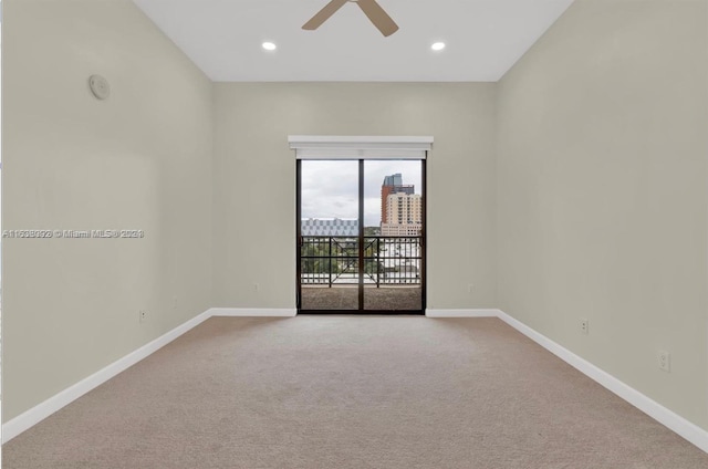 unfurnished room with carpet flooring and ceiling fan