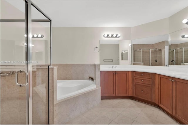 bathroom featuring vanity, tile patterned flooring, and separate shower and tub