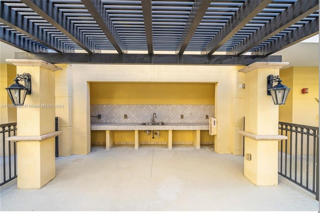 view of patio / terrace featuring a pergola and sink