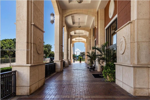 hallway featuring decorative columns