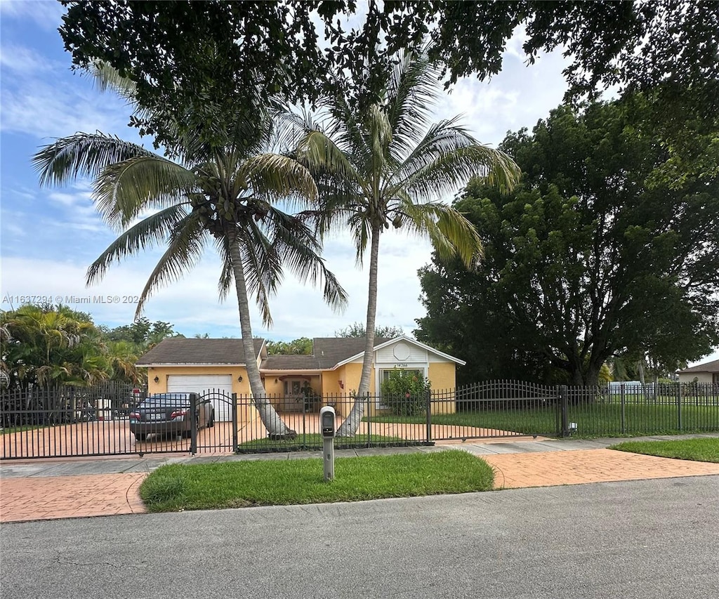 view of front of home featuring a garage and a front lawn