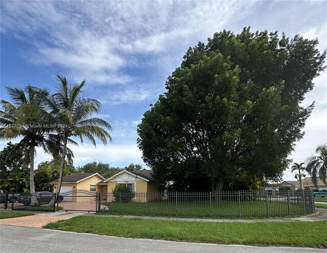 view of front of home featuring a garage and a front lawn