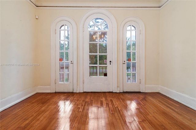 entryway with crown molding and hardwood / wood-style flooring