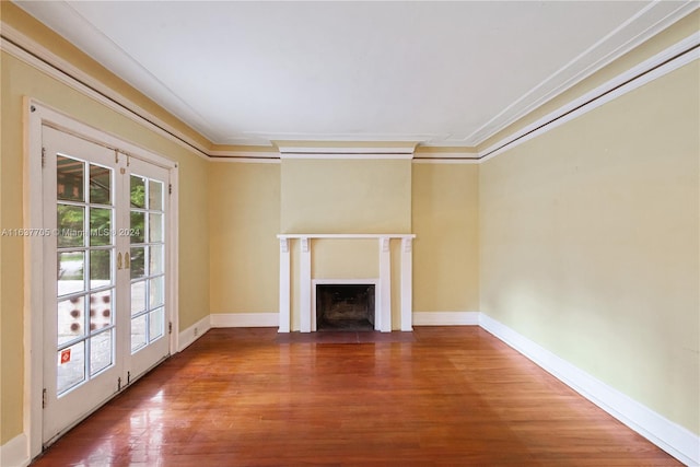 unfurnished living room featuring wood-type flooring, french doors, and crown molding