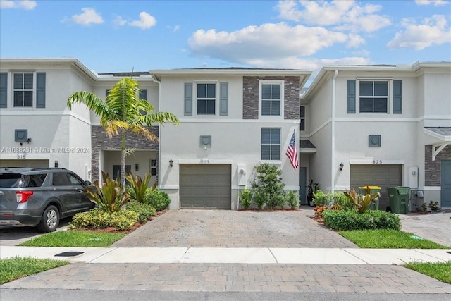 townhome / multi-family property featuring a garage