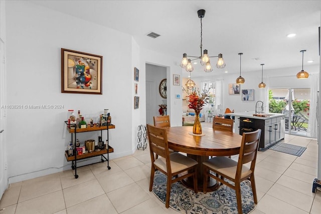 dining room featuring light tile patterned flooring, sink, and an inviting chandelier