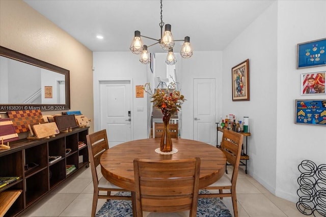 tiled dining room with a chandelier