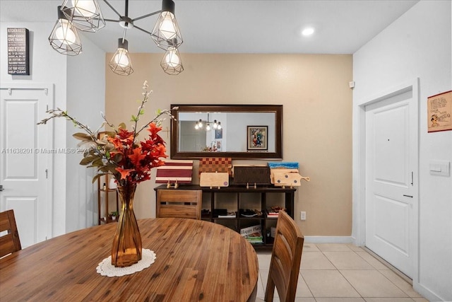 tiled dining area featuring an inviting chandelier