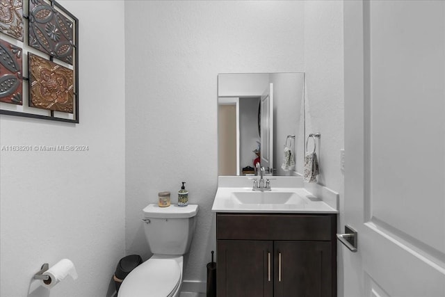 bathroom featuring toilet and vanity