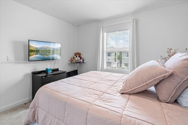 bedroom featuring light carpet