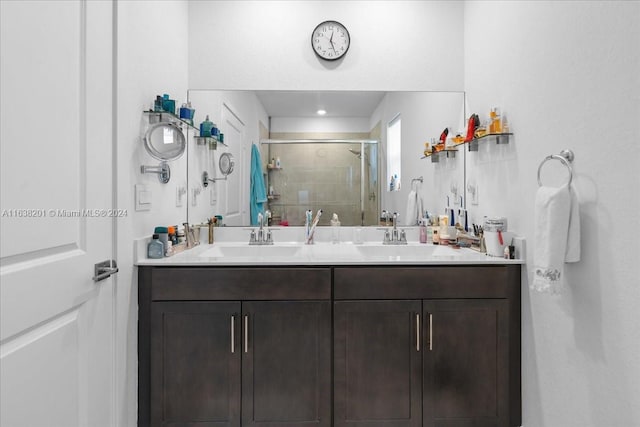 bathroom featuring walk in shower and dual vanity