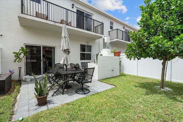 view of yard with a balcony and a patio area