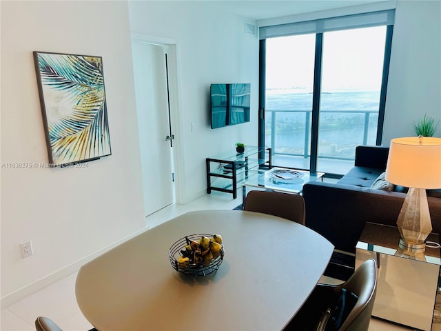 tiled dining area featuring a wall of windows