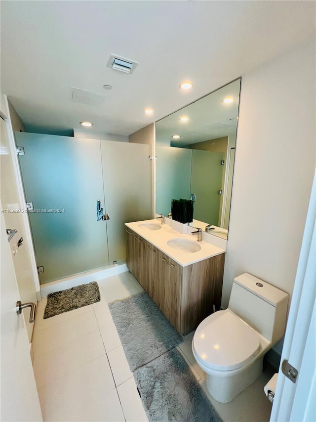 full bath with a shower stall, visible vents, toilet, and a sink