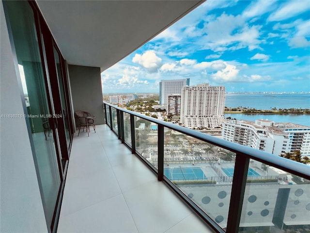 balcony with a view of city and a water view