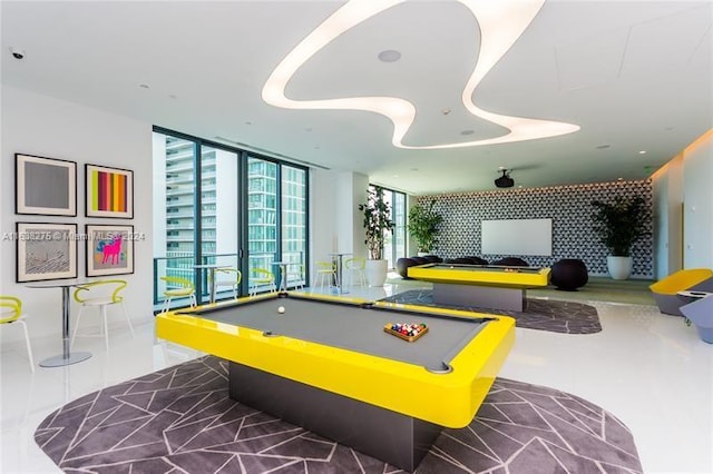 recreation room with floor to ceiling windows and pool table