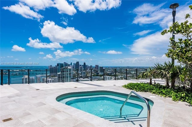 view of swimming pool with a view of city, a swimming pool, and fence