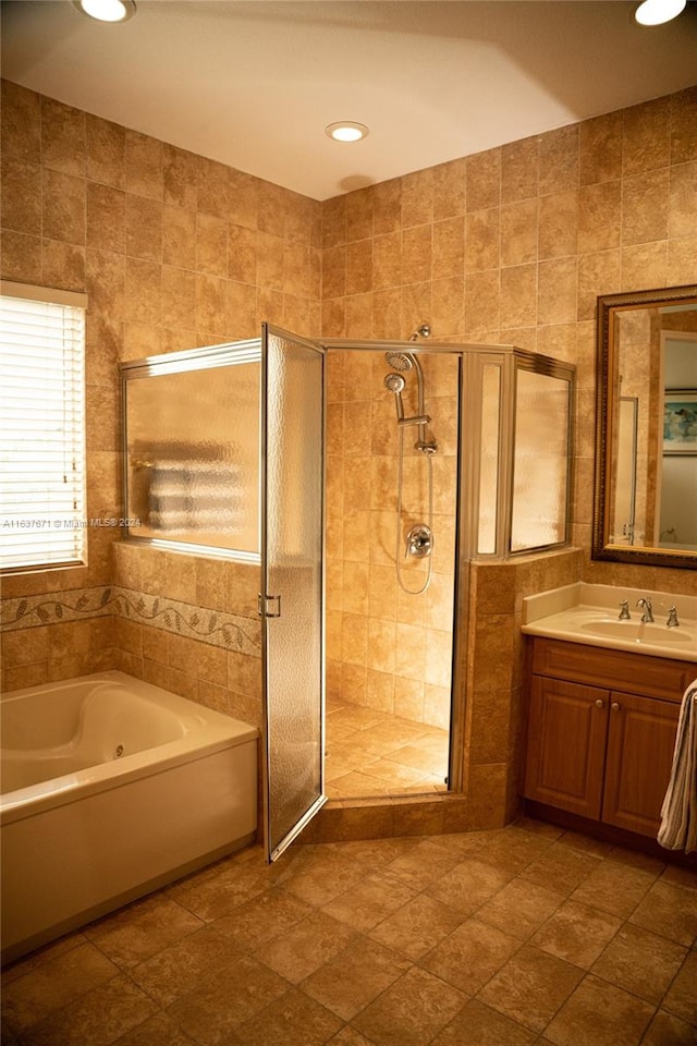 bathroom with tile walls and separate shower and tub