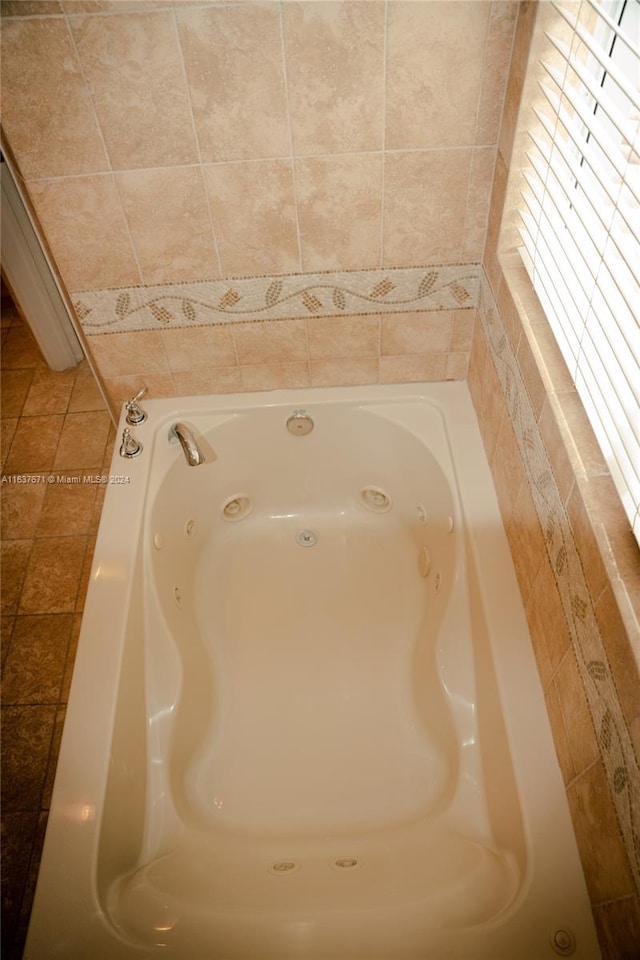 room details with tile patterned flooring and a bathtub