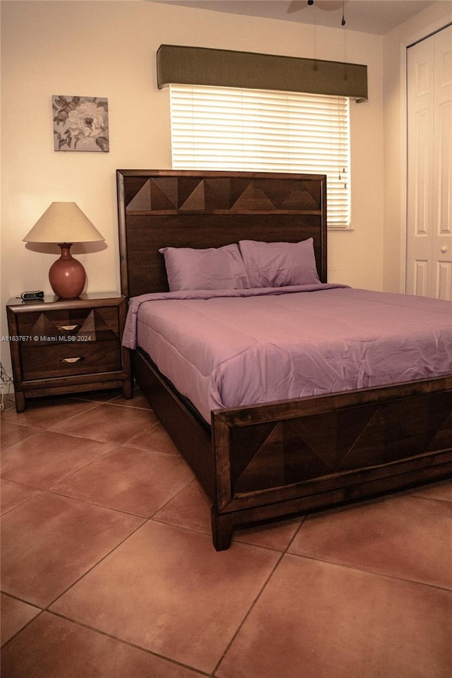 tiled bedroom with a closet