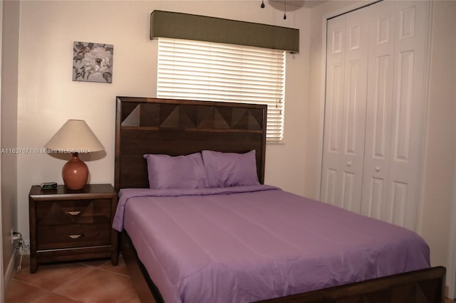 tiled bedroom featuring a closet