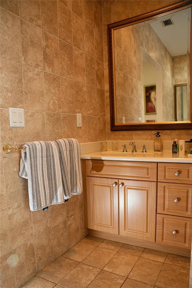 bathroom with vanity, tile walls, and tile patterned floors