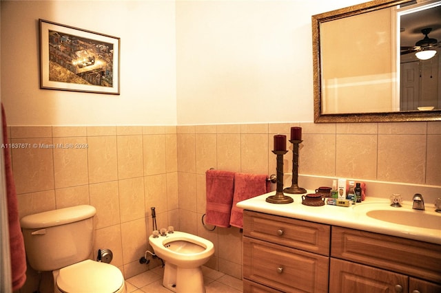 bathroom with a bidet, tile walls, toilet, and tile patterned floors