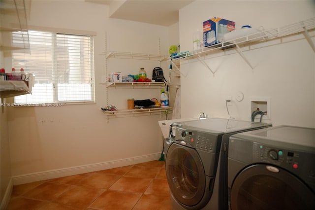 washroom featuring washing machine and dryer and tile patterned floors