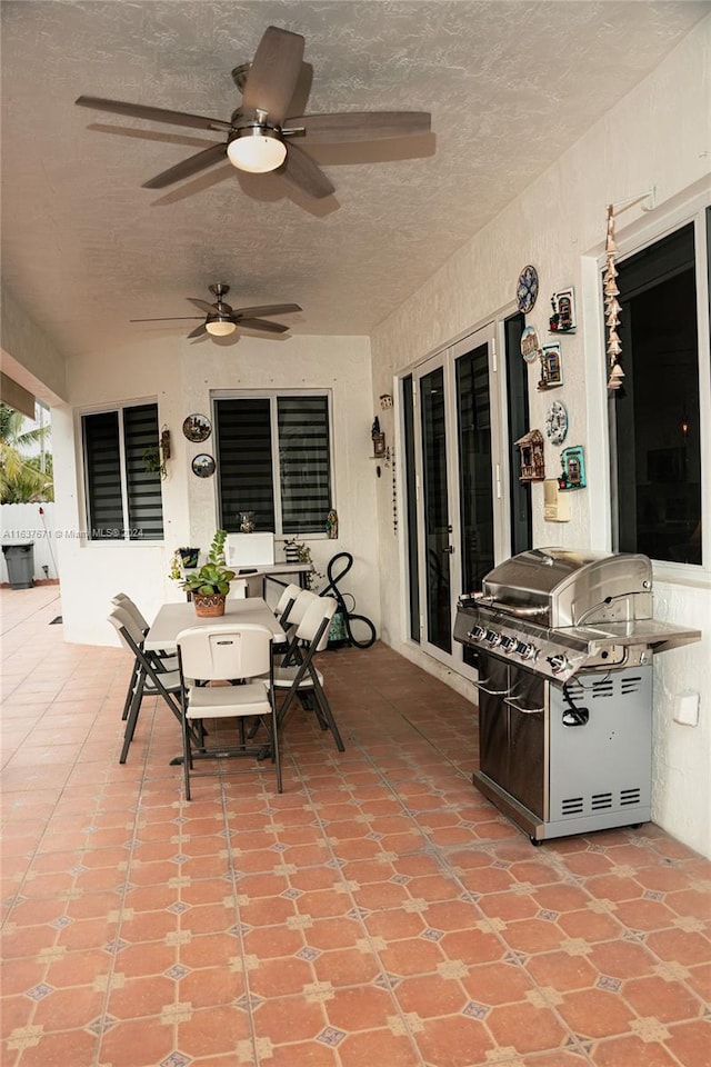 view of patio with ceiling fan and a grill