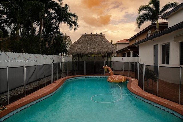 view of pool at dusk