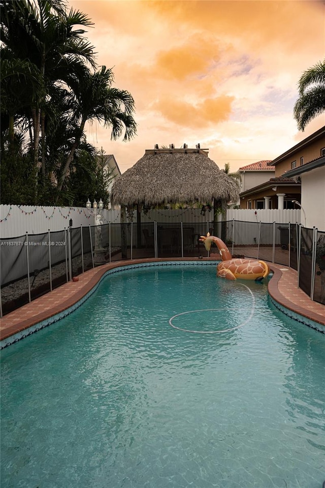 pool at dusk with a water slide