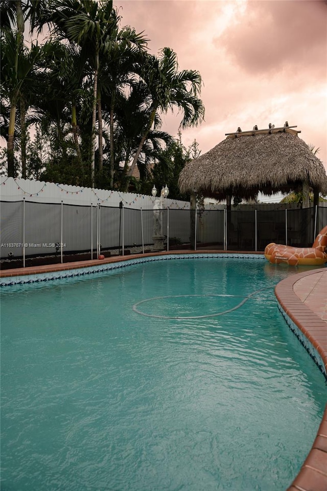 view of pool at dusk