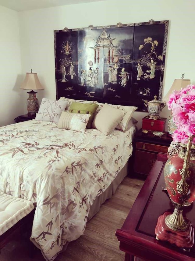bedroom with hardwood / wood-style floors