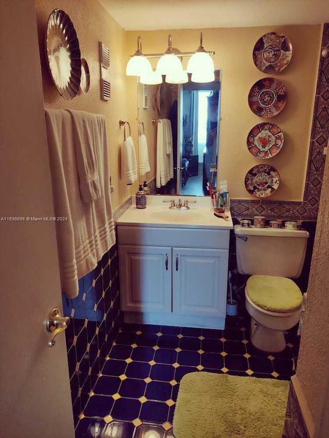 bathroom with vanity, toilet, and tile patterned flooring