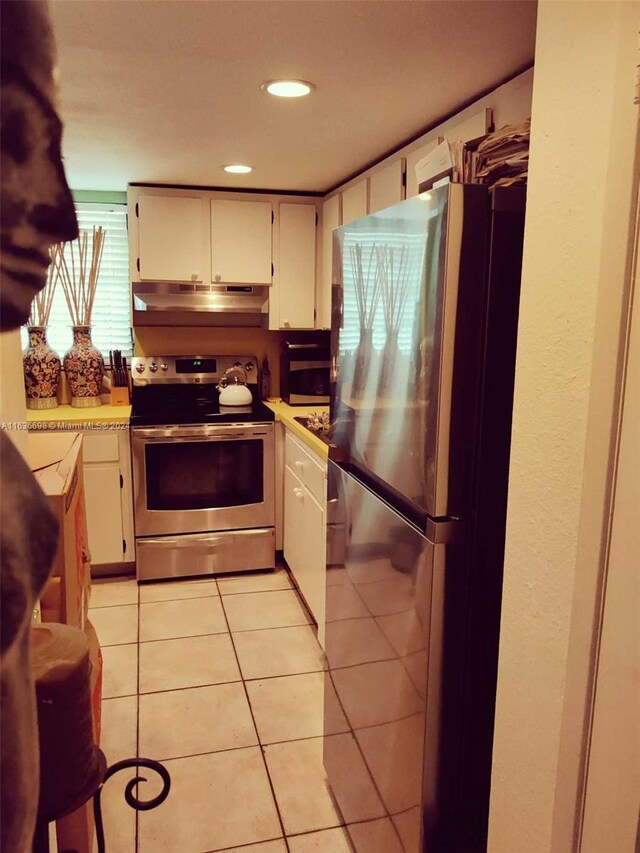 kitchen featuring appliances with stainless steel finishes and light tile patterned floors