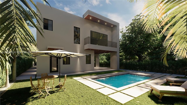 rear view of house with a patio, stucco siding, a lawn, a balcony, and an outdoor pool