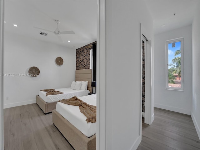 bedroom with ceiling fan and light wood-type flooring