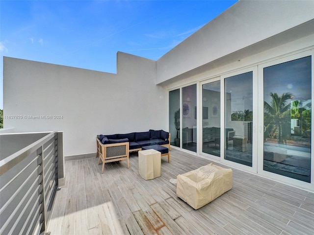 wooden terrace with an outdoor living space