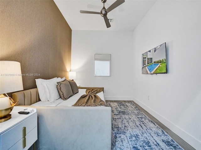 bedroom with wood-type flooring and ceiling fan