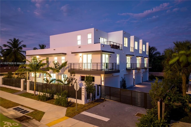 view of front of house with a garage and a balcony