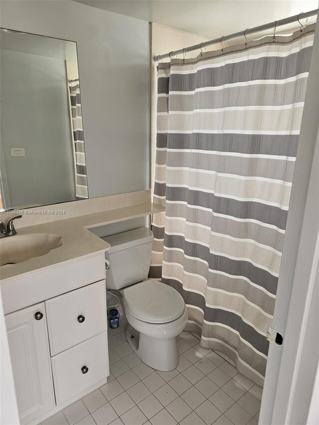 bathroom with vanity, tile patterned floors, and toilet