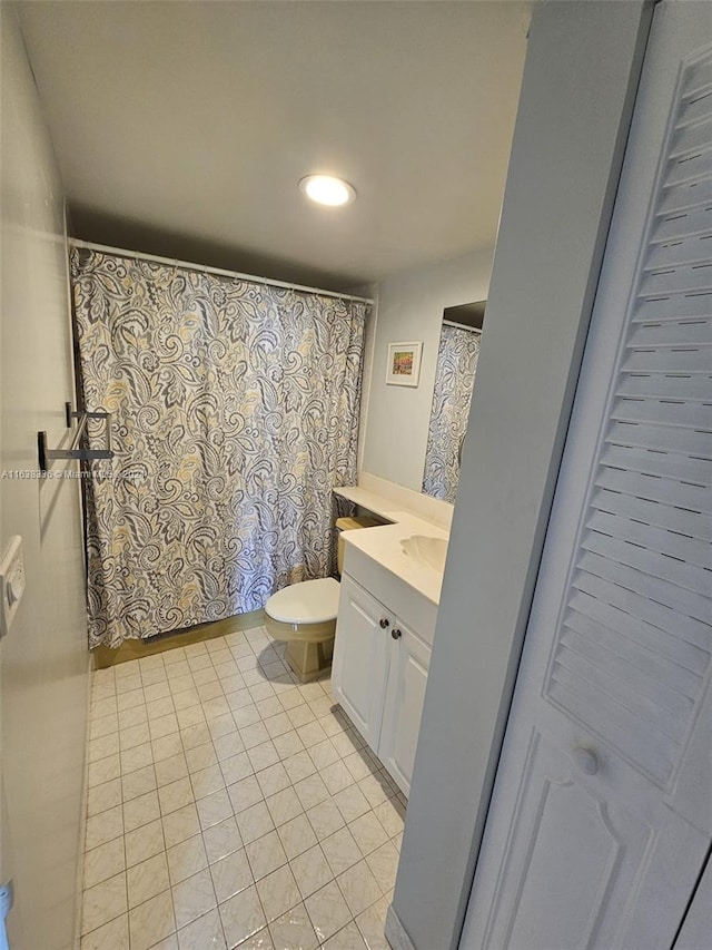 bathroom featuring tile patterned flooring, vanity, toilet, and a shower with curtain