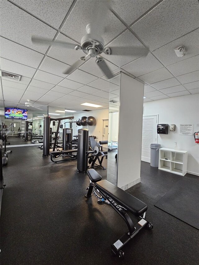 gym featuring a paneled ceiling and ceiling fan